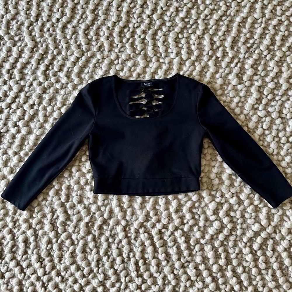 Black scoop neck, 3/4 sleeve top, knotted back. Fits small/medium.